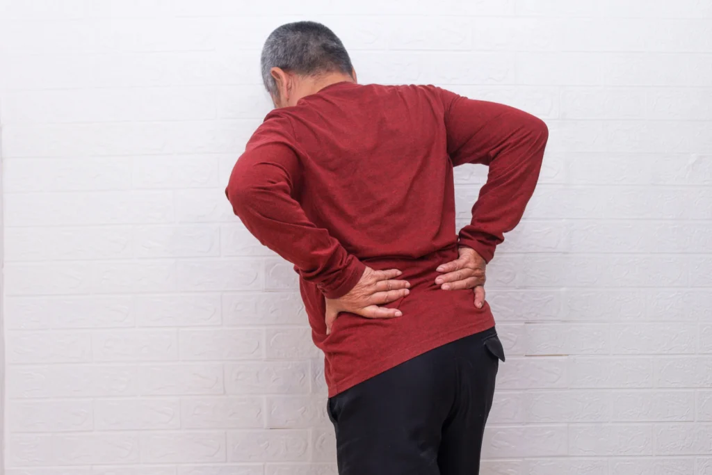 adult massaging lower back due to pain 2026 03 24 10 12 58 utc