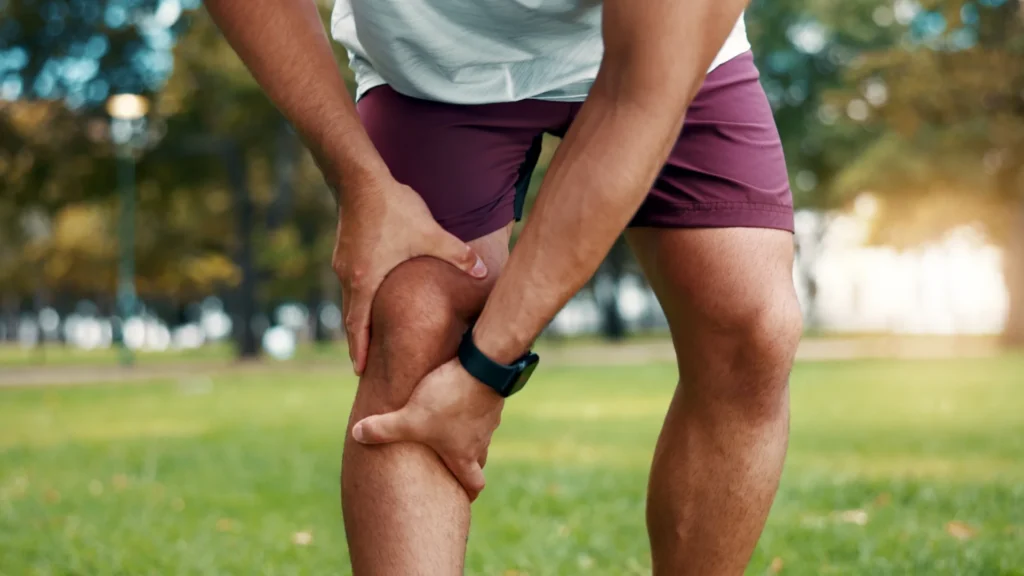 athlete holding injured knee during outdoor exerci 2026 06 15 19 43 54 utc