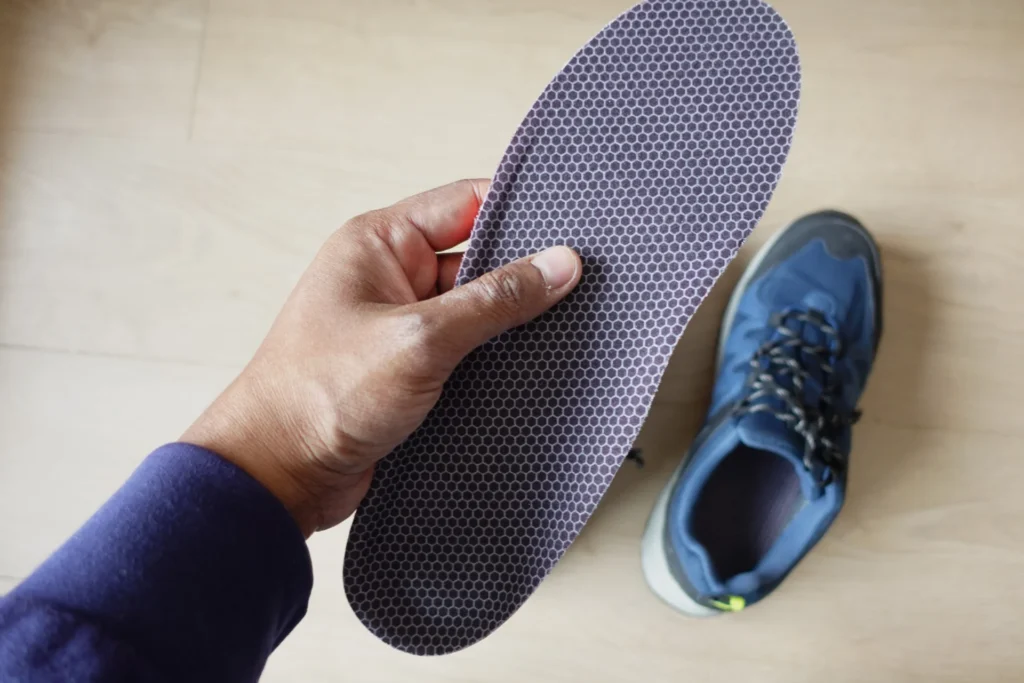 hand holding a new orthopedic shoe insole 2026 03 16 03 24 52 utc