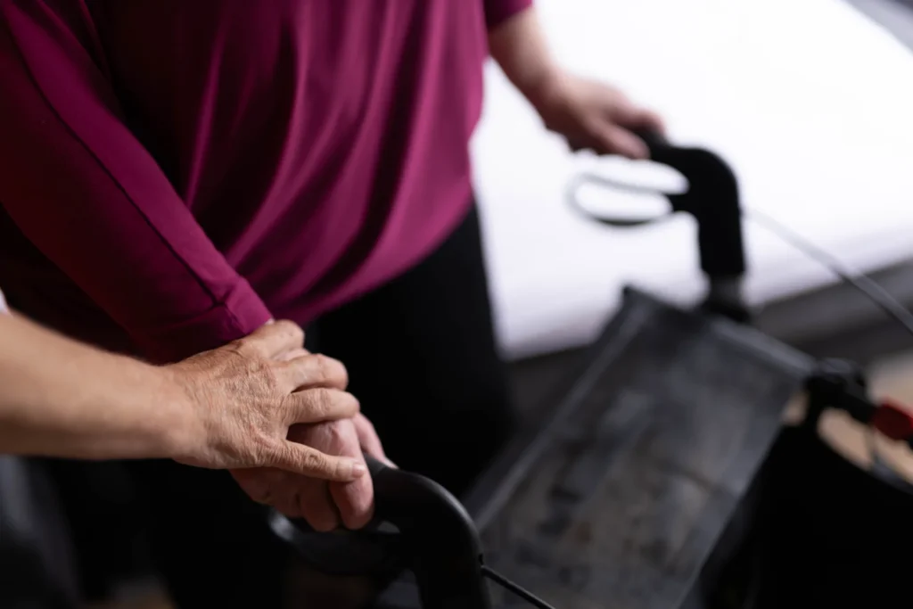 supportive caregiver assists senior using walker 2026 03 25 09 13 59 utc