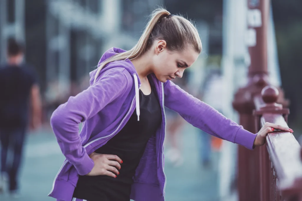 woman in athletic wear resting outside after worko 2026 03 10 04 49 11 utc