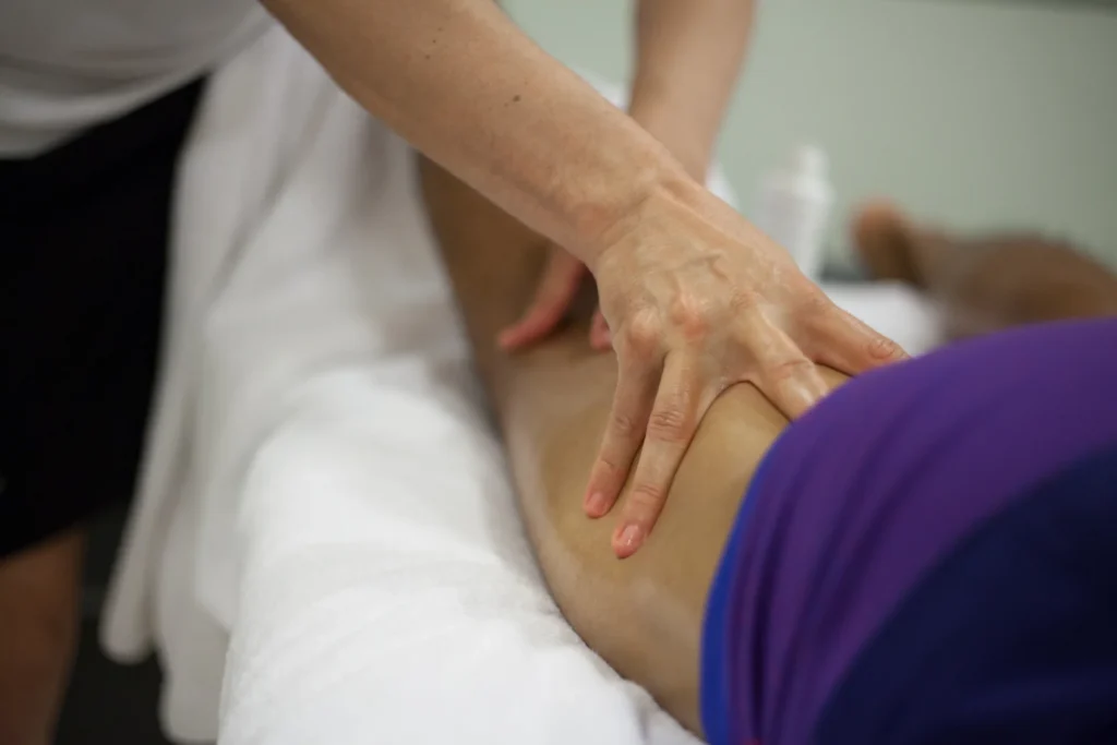 therapist massaging leg of patient on table 2026 01 07 01 40 34 utc
