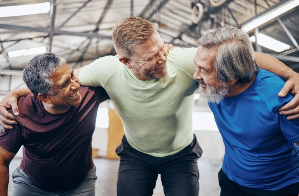 three men embrace after workout at the gym 2026 09 22 04 30 48 utc