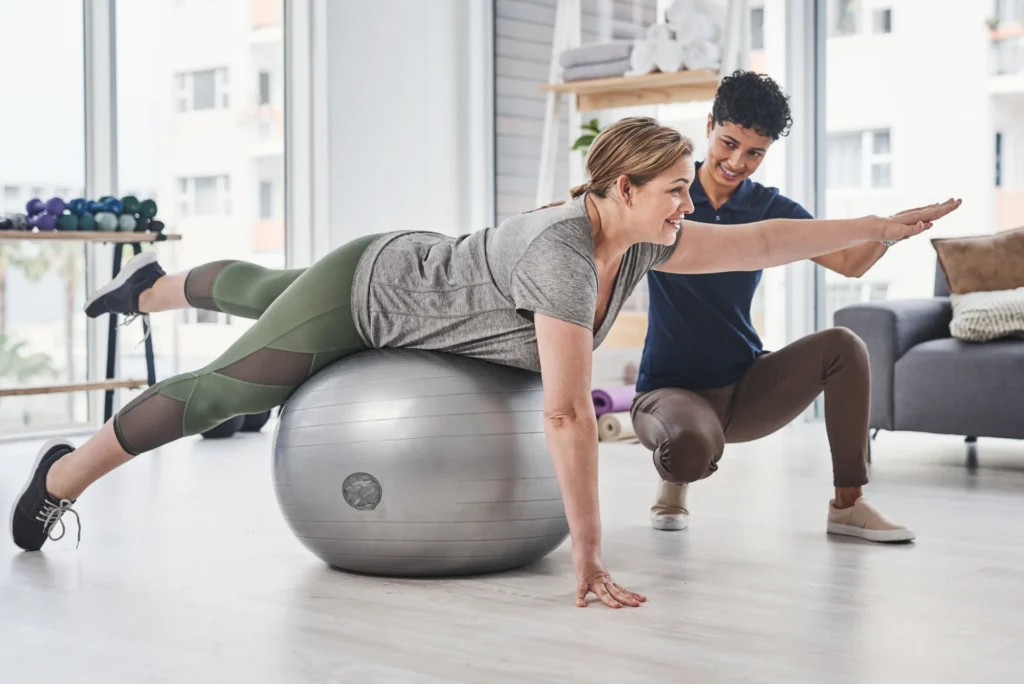 woman exercising with trainer on exercise ball 2026 01 09 09 51 53 utc