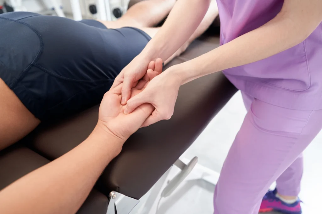 woman hand therapy session for patient on table 2026 03 10 03 13 38 utc