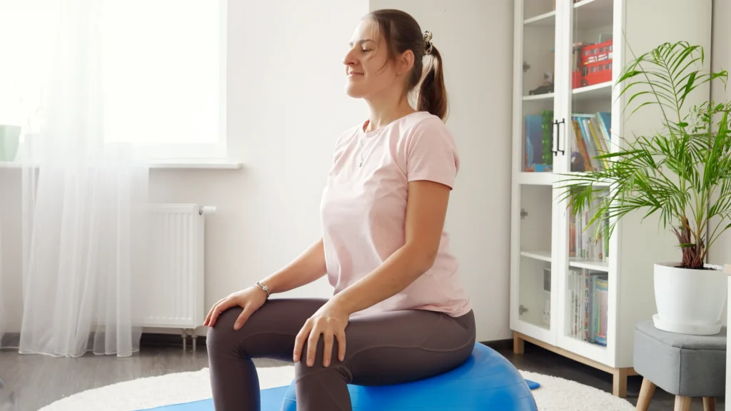 woman meditating peacefully on exercise ball at ho 2026 01 07 00 35 35 utc